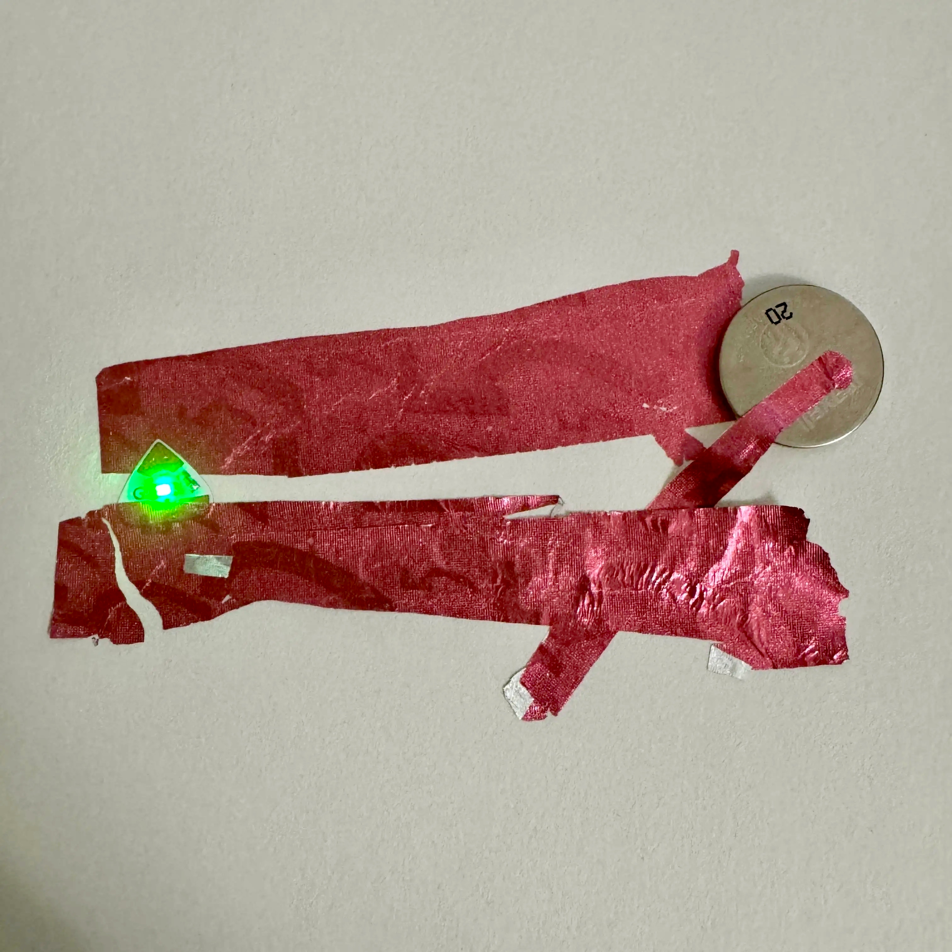 After a Google search, I found out gum wrapper is actually conductive, but something about the last circuit didn't work for some reason? I think there wasn't enough contact with the negative side of the LED sticker. Also, the foil might be too thin to fold it over like the copper tape because when I didn't bend the foil this time, it worked!