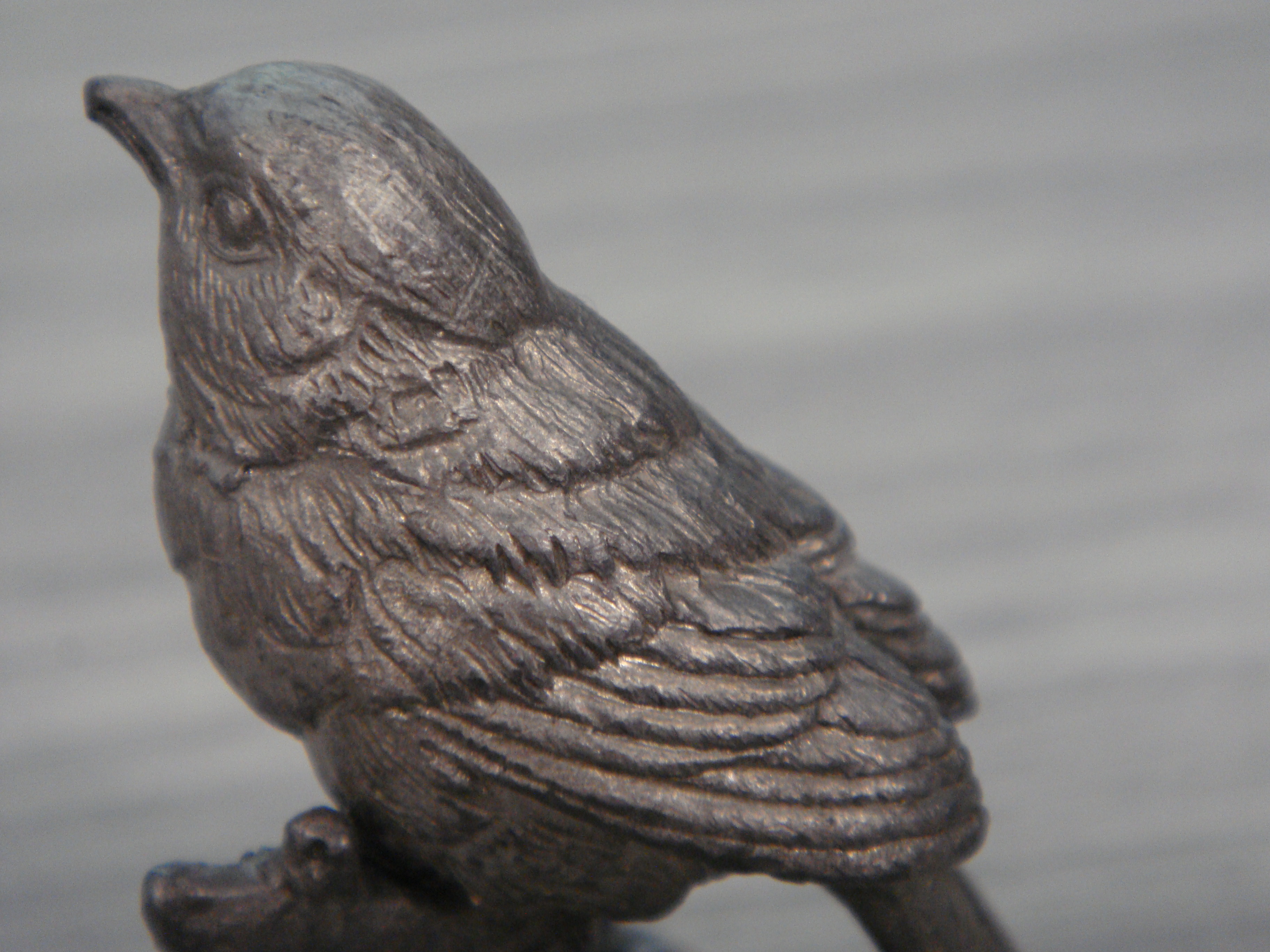 This beautiful metal sculpture of a bird immediately caught my eye. The highlights of the metal almost bring the bird to life in a way? It replicates the natural highlights in a bird's feathers. It's really cool how artists that work with monochrome materials—like wood, unpainted ceramics, etc—are able to make each aspect of their subject so distinct without the use of color. When working with such materials, it's clear that visual elements other than color must be explored and leveraged in order to create a capitvating piece.
